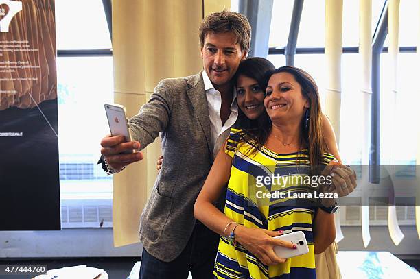 Fans take a selfie with actor Roberto Farnesi while attending a cocktail at Cuoio di Toscana during the Pitti Uomo 88 at Fortezza da Basso on June...