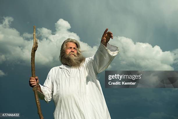 long-haired prophet pointing in front of dramatic sky - god sky stock pictures, royalty-free photos & images