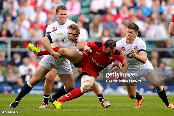 Jamie Roberts of Wales is stopped by Joe Marler and Owen Farrell of England during the RBS Six Nations match between England and Wales at Twickenham...