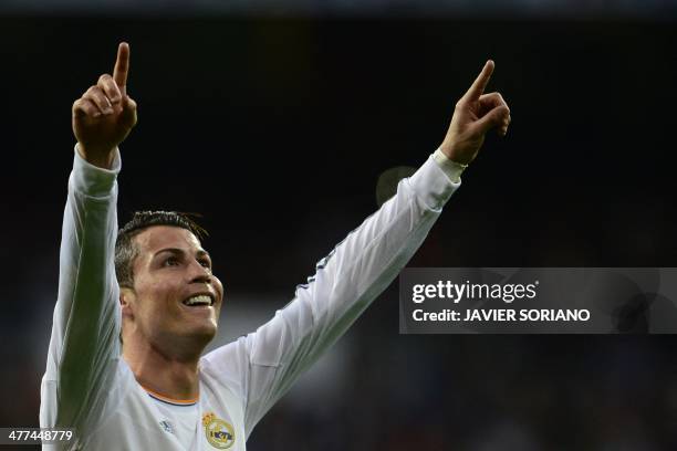 Real Madrid's Portuguese forward Cristiano Ronaldo celebrates after scoring their first goal during the Spanish league football match Real Madrid CF...