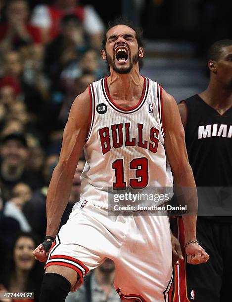Joakim Noah of the Chicago Bulls celebrates after being fouled during a game against the Miami Heat at the United Center on March 9, 2014 in Chicago,...