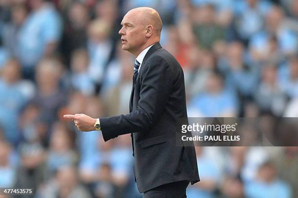 Wigan Athletic's German manager Uwe Rosler gestures from the touchline during the English FA Cup quarter-final football match between Manchester City...