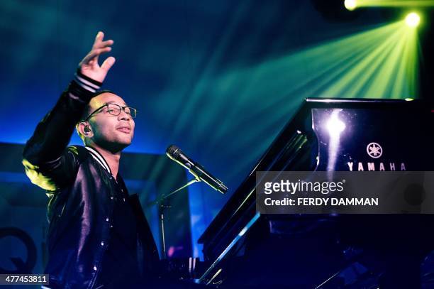 Singer John Legend performs in the Qube in Amsterdam during a concert for a select group of listeners of Dutch radio station QMusic on March 9, 2014....
