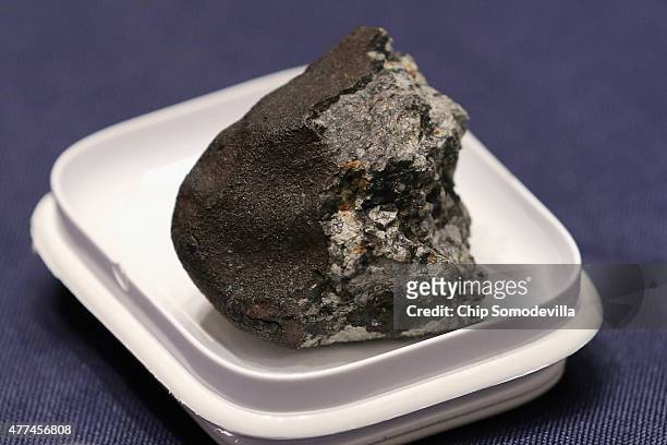 Piece of the Chelyabinsk meteorite is displayed before a hearing of the House Administration Committee in the Longworth House Office Building on...
