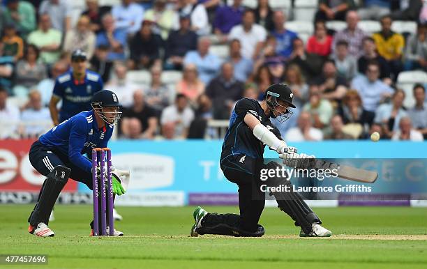 Mitchell Santner of New Zealand smashes the ball to the boundary in front of Jos Butler of England during the 4th ODI Royal London One-Day...