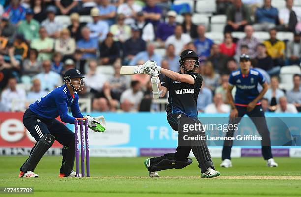 Mitchell Santner of New Zealand smashes the ball to the boundary in front of Jos Butler of England during the 4th ODI Royal London One-Day...
