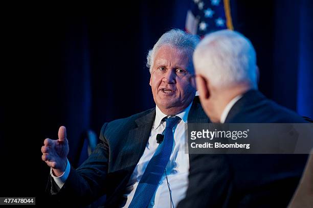 Jeffrey "Jeff" Immelt, chairman and chief executive officer of General Electric Co. , left, speaks with David Rubenstein, co-founder and co-chief...