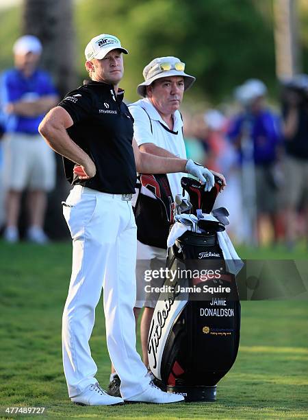 Jamie Donaldson of Wales waits with his caddie Mick Donaghy on the 18th hole during the final round of the World Golf Championships-Cadillac...
