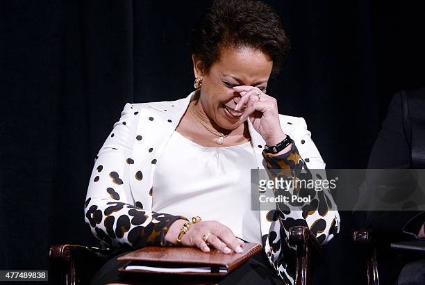Attorney General Loretta Lynch reacts to U.S. President Barack Obama's speech during a formal investiture ceremony at the Warner Theatre June 17,...