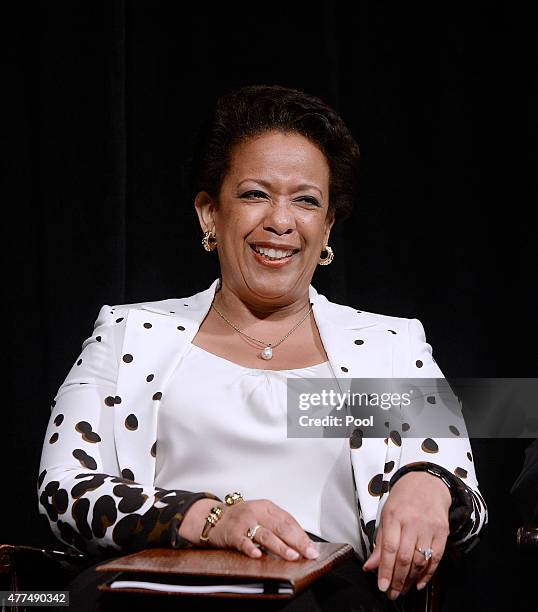 Attorney General Loretta Lynch reacts to U.S. President Barack Obama's speech during a formal investiture ceremony at the Warner Theatre June 17,...