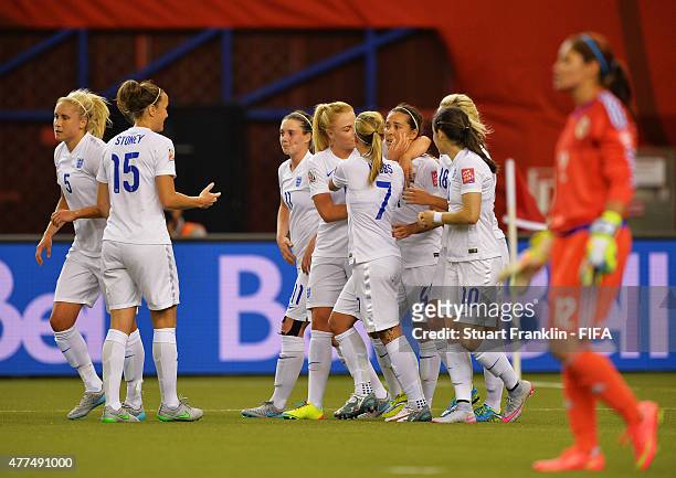 Fara Williams of England celebrates scoring her penalty goal with teamates during the FIFA Womens's World Cup Group F match between England and...