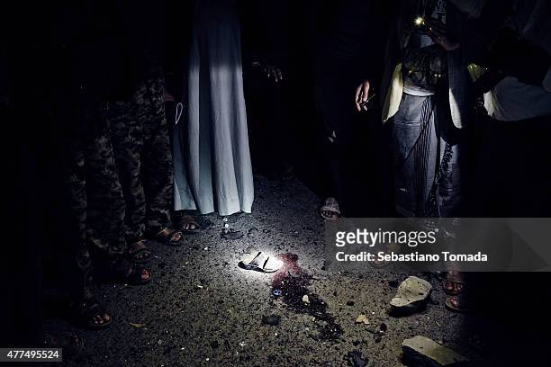Shoe belonging to a child wounded by a car-bomb used against Houthi officials' residences lies on the ground on June 17, 2015 in Sana'a, Yemen. News...