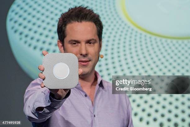 Maxime Veron, director of product marketing at Nest Labs Inc., holds the new Nest Protect smoke alarm as he speaks during a Nest Labs event in San...