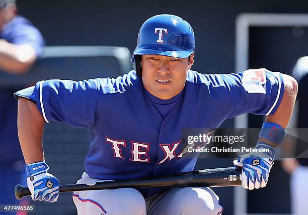 Kensuke Tanaka of the Texas Rangers prepares to bat against the Seattle Mariners during the spring training game at Peoria Stadium on March 9, 2014...