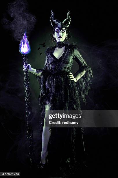 evil sorceress in black gown and magic staff - hiking pole stock pictures, royalty-free photos & images