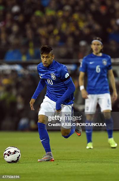 Brazil's forward Neymar takes control of the ball during their Copa America football match against Colombia, at the Estadio Monumental David Arellano...