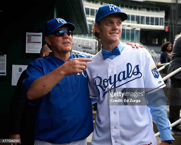 After signing with the Kansas City Royals, number one draft pick Ashe Russell meets with manager Ned Yost of the Kansas City Royals prior to a game...