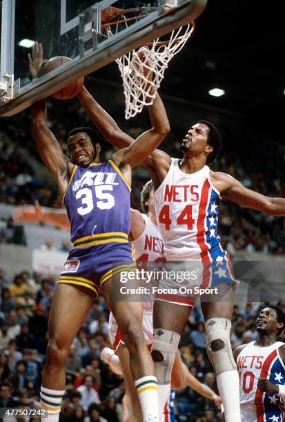 Darrell Griffith of the Utah Jazz has his shot blocked by Cliff Robinson of the New Jersey Nets during an NBA basketball game circa 1980 at the...