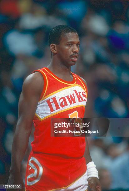 Eddie Johnson of the Atlanta Hawks looks on while there's a break in the action against the Washington Bullets during an NBA basketball game circa...