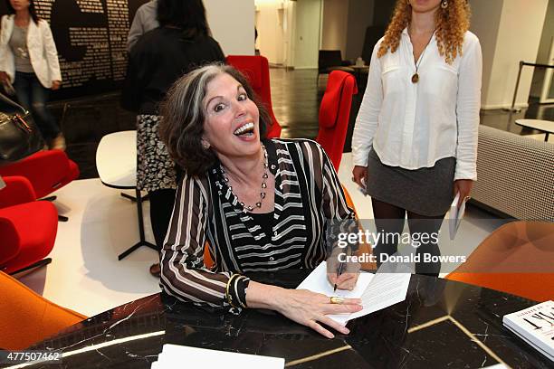 Gina Barnett signs a copy of her book during her book release party for "Play the Part" at GLG on June 17, 2015 in New York City.