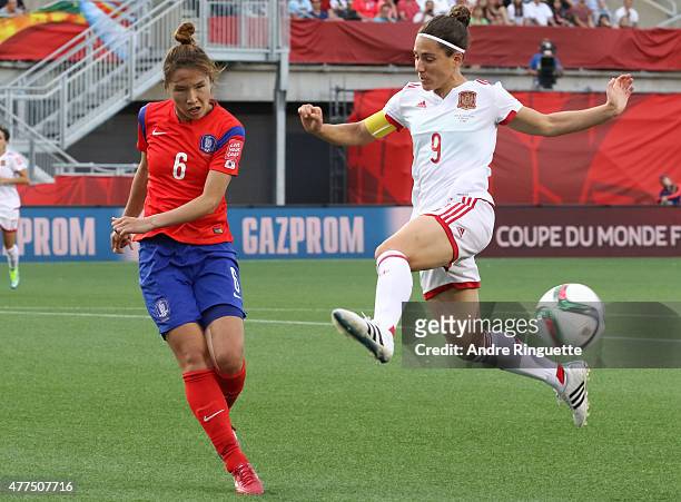 Boram Hwang of Korea Republic kicks the ball away from Veronica Boquete of Spain during the FIFA Women's World Cup Canada 2015 Group E match between...