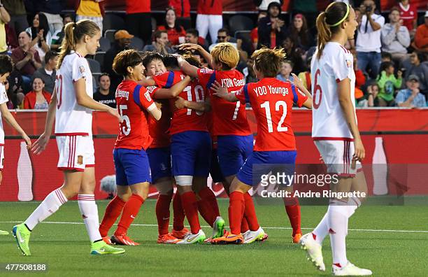 Sooyun Kim of Korea Republic is congratulated by her team mates after scoring her team's second goal during the FIFA Women's World Cup Canada 2015...