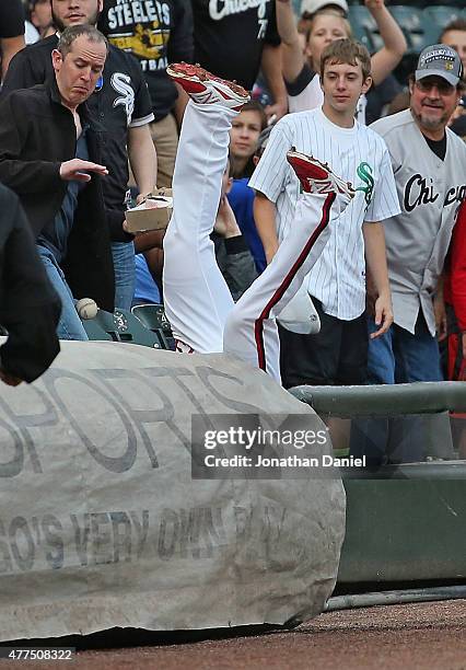 Gordon Beckham of the Chicago White Sox falls over the tarp trying to catch a foul ball against the Pittsburgh Pirates in the 2nd inning at U.S....