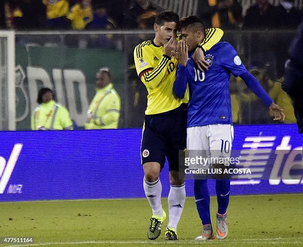 Brazil's forward Neymar and Colombia's midfielder James Rodriguez whisper at the end of their Copa America football match at the Estadio Monumental...