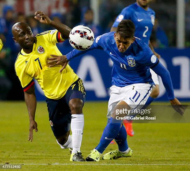 Roberto Firmino of Brazil fights for the ball with Pablo Armero of Colombia during the 2015 Copa America Chile Group C match between Brazil and...