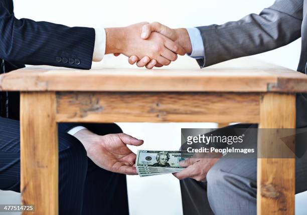 under-the-table transactions... - suspicion stock pictures, royalty-free photos & images