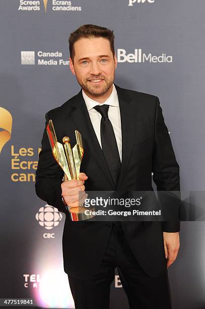 Jason Priestley, winner of the Best Perfomance by an Actor in a Continuing Leading Comedic Role poses in the press room at the 2014 Canadian Screen...