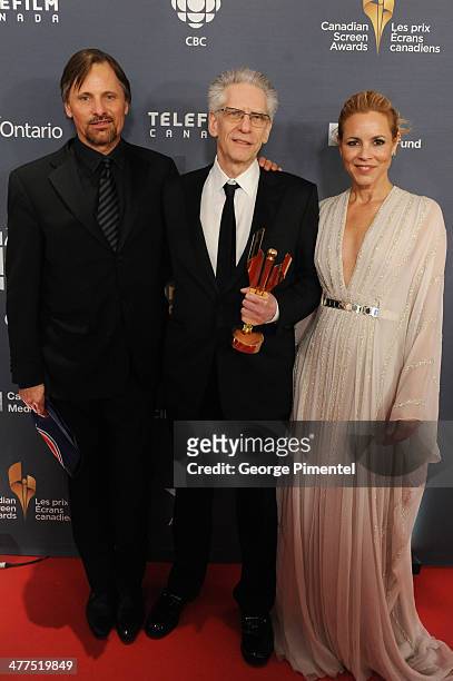 Viggo Mortensen, David Cronenberg and Maria Bello pose in the press room at the 2014 Canadian Screen Awards at Sony Centre for the Performing Arts on...