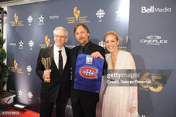 David Cronenberg, Viggo Mortensen and Maria Bello pose in the press room at the 2014 Canadian Screen Awards at Sony Centre for the Performing Arts on...