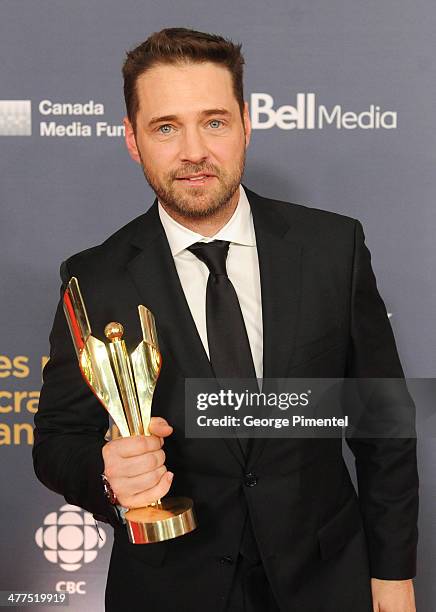 Jason Priestley, winner of the Best Perfomance by an Actor in a Continuing Leading Comedic Role poses in the press room at the 2014 Canadian Screen...