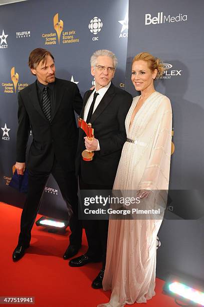 Viggo Mortensen, David Cronenberg and Maria Bello pose in the press room at the 2014 Canadian Screen Awards at Sony Centre for the Performing Arts on...