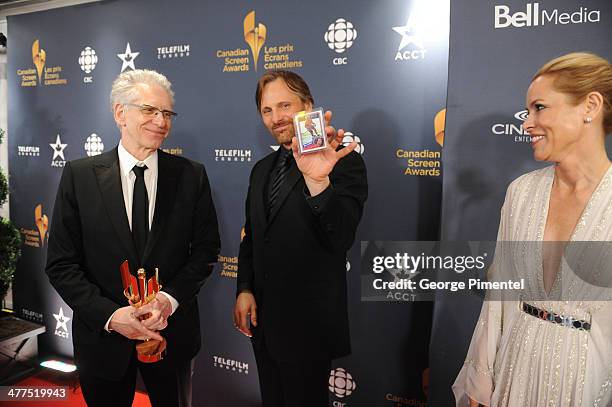David Cronenberg, Viggo Mortensen and Maria Bello pose in the press room at the 2014 Canadian Screen Awards at Sony Centre for the Performing Arts on...