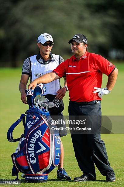 Patrick Reed speaks with his caddie Kessler Karin while playing on the 12th hole during the final round of the World Golf Championships-Cadillac...