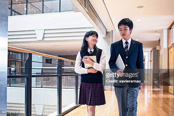 japanese students walking in the school corridors - japan 12 years girl stock pictures, royalty-free photos & images
