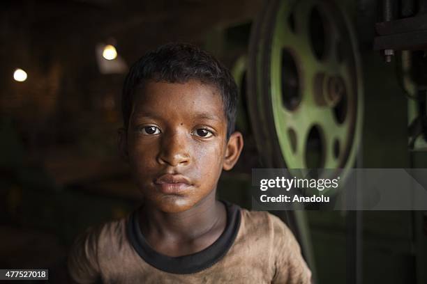 Child worker is seen on duty at the shipyard near Dhaka on June 17, 2015. Child labor problem is not a new issue in Bangladesh. Poverty leads many...