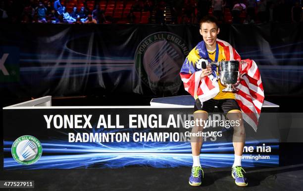 Lee Chong Wei of Malaysia celebrates with his trophy after beating Chen Long of China in their All England Open Badminton Championships men's singles...