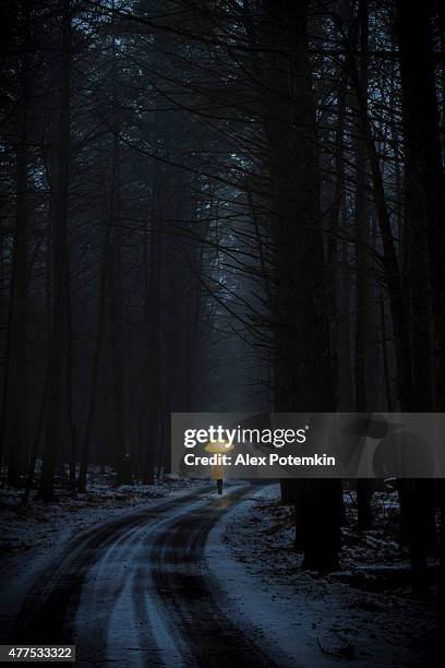 little girl in the dark forest - girl rain night stock pictures, royalty-free photos & images