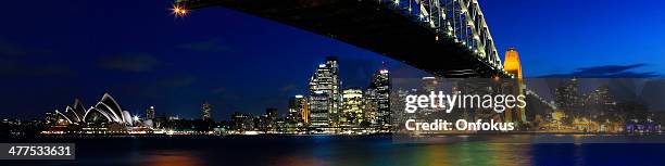 sydney cityscape with opera house and harbour bridge at night - luna park sydney stockfoto's en -beelden