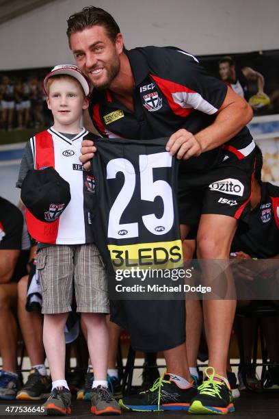 Sam Fisher poses with a fan after receiving his jumper during a St Kilda Saints AFL Fan Day at Frankston Foreshore on March 10, 2014 in Melbourne,...