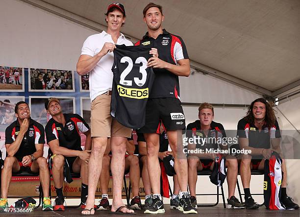 Justin Koschitzke presents Spencer White his jumper during a St Kilda Saints AFL Fan Day at Frankston Foreshore on March 10, 2014 in Melbourne,...