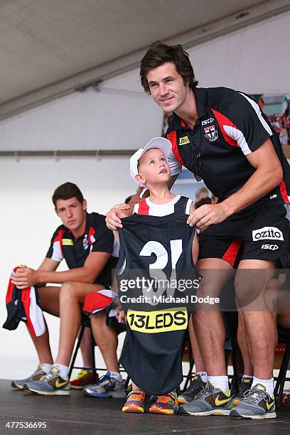 Tom Simpkin poses with a fan after receiving his jumper during a St Kilda Saints AFL Fan Day at Frankston Foreshore on March 10, 2014 in Melbourne,...