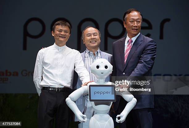 Billionaire Jack Ma, chairman of Alibaba Group Holding Ltd., left, billionaire Masayoshi Son, chairman and chief executive officer of SoftBank Corp.,...