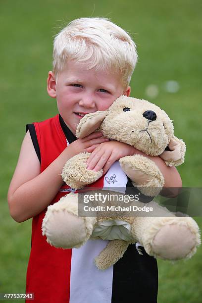 Saints fan cuddles a teddy bear during a St Kilda Saints AFL Fan Day at Frankston Foreshore on March 10, 2014 in Melbourne, Australia.