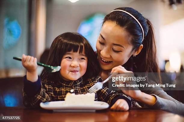 mom & toddler girl having cake joyfully in cafe - cheesecake stock pictures, royalty-free photos & images