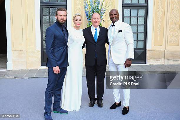 Prince Albert II of Monaco and Princess Charlene of Monaco pose with actors Terry Crews and Clive Standen during the Monaco Palace cocktail party of...