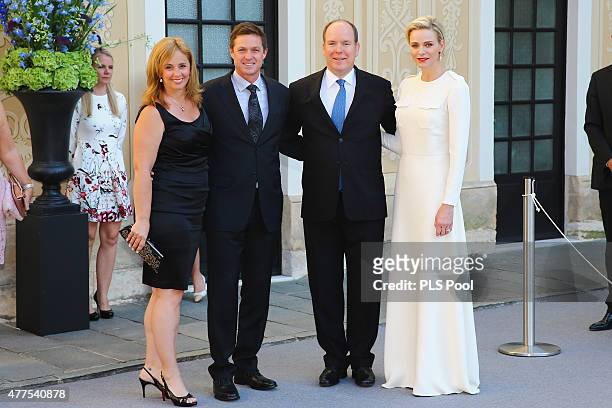 Prince Albert II of Monaco and Princess Charlene of Monaco pose with actor and jury member Eric Close and wife during the Monaco Palace cocktail...